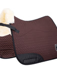 Brown quilted saddle pad with black border and white fur on a white background