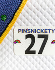 Pinsnickety Clover and Rainbow horse show number pins on a saddle and a bonnet. Lucky charms.