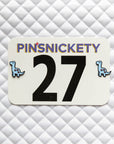 Pinsnickety Brontosaurus horse show number pins on a saddle pad.
