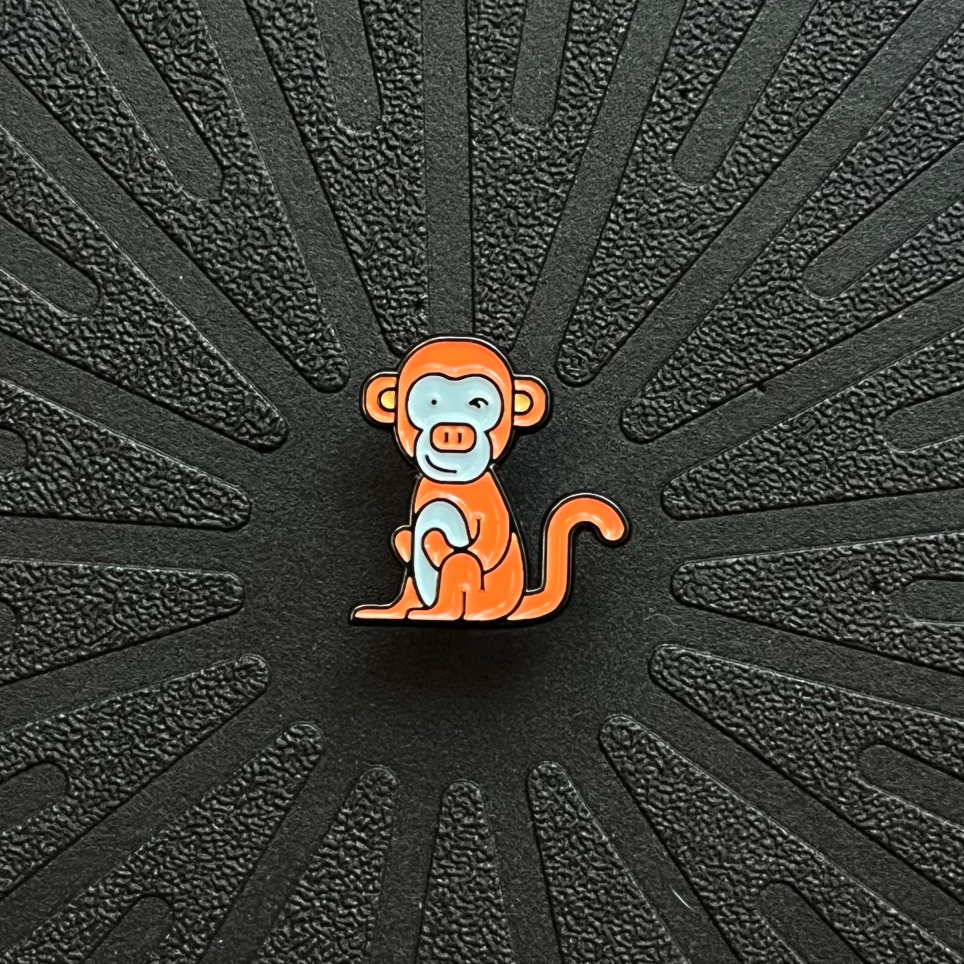a single pinsnickety monkey horse show number pin on a black background