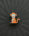 a single pinsnickety monkey horse show number pin on a black background