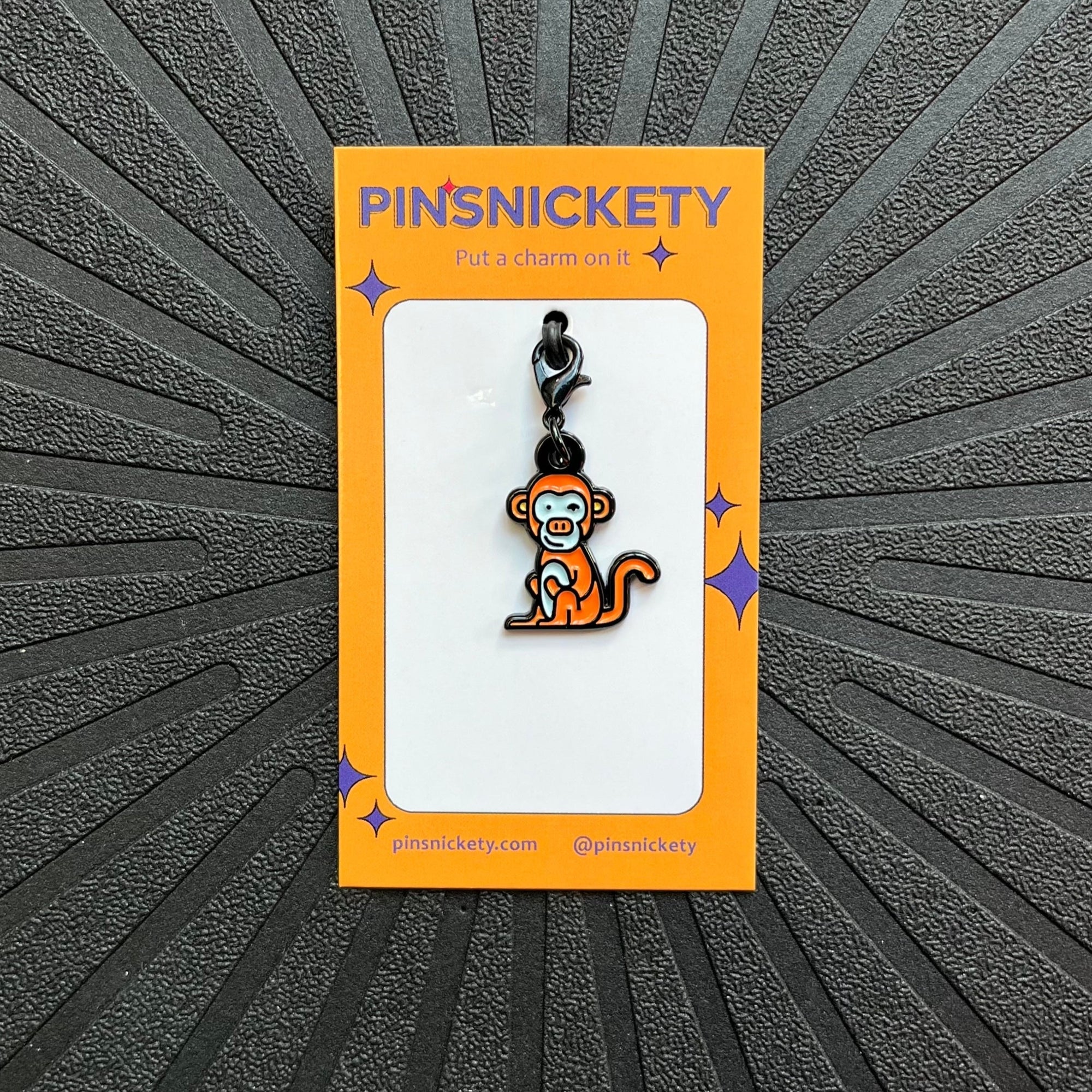 pinsnickety monkey bridle charm on a black background