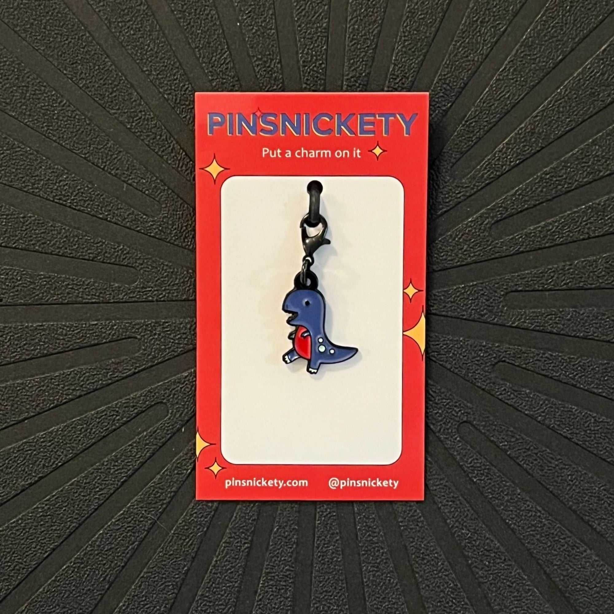 Pinsnickety T-Rex braid and bridle charm on a black background
