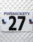 pinsnickety t-rex horse show number pins on a saddle pad