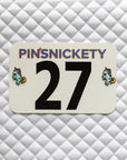 Pinsnickety Flying Unicorn horse show number pins on a saddle pad