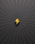 pinsnickety lightning bolt horse show number pin in special edition electric yellow alone on a black background