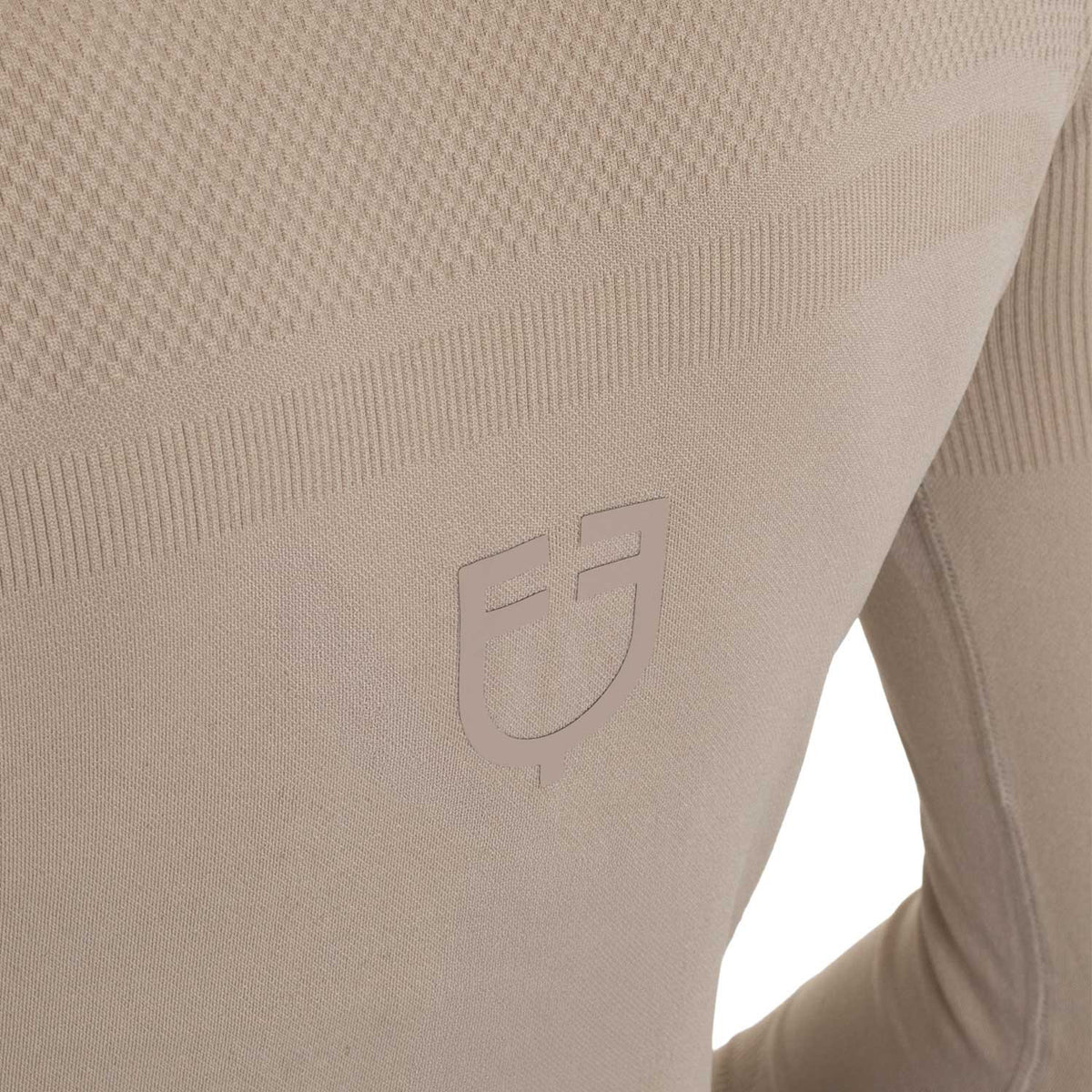 Close-up of the Equestro training shirt knit texture with embossed tonal Equestro shield emblem