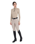 Rider wearing the Equestro Cobblestone technical knit training shirt with matching breeches and black tall boots