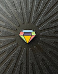 Pinsnickety gem horse show number pin alone on a black background