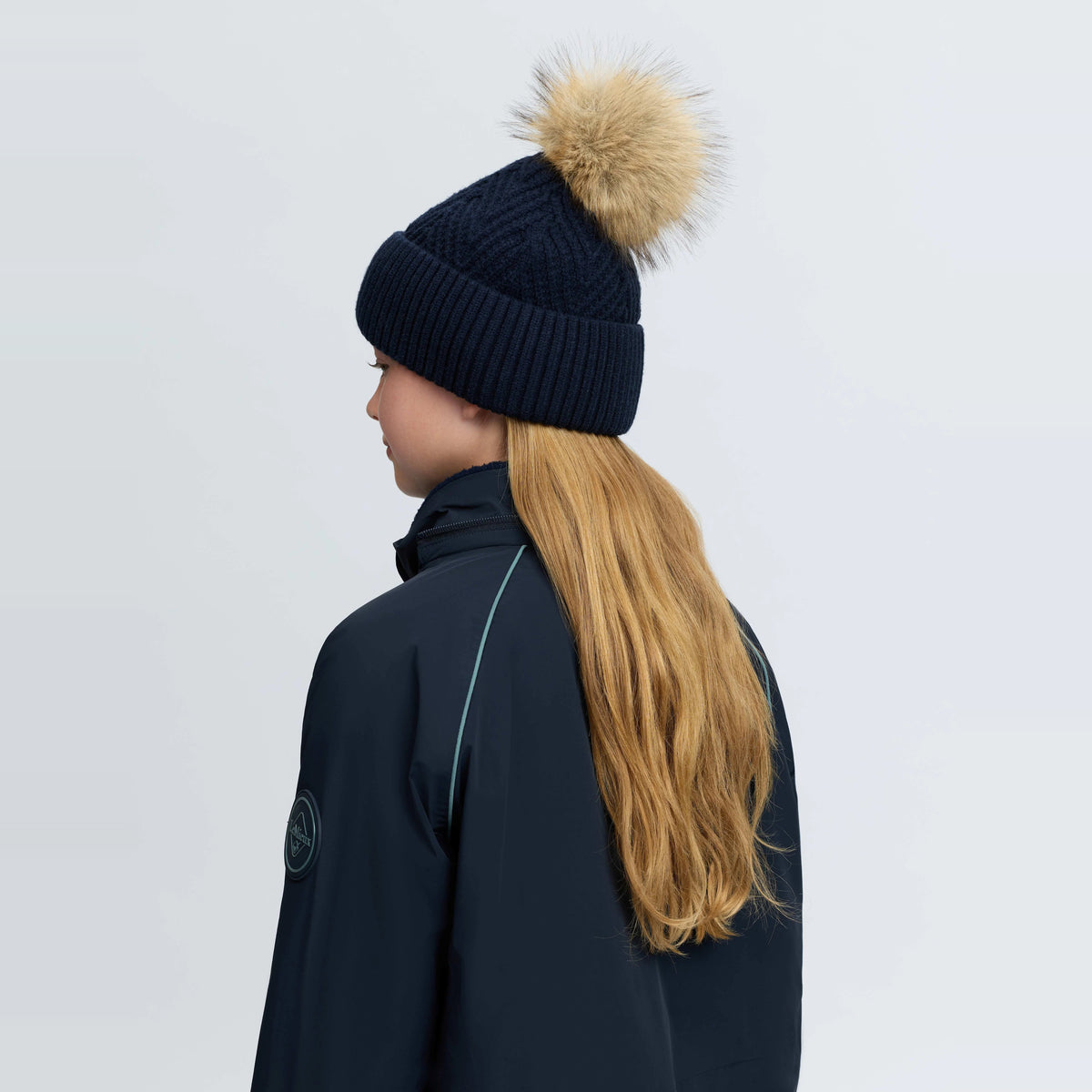 LeMieux Clara Rib Beanie in Navy, back view showing ribbed knit construction and faux fur pom