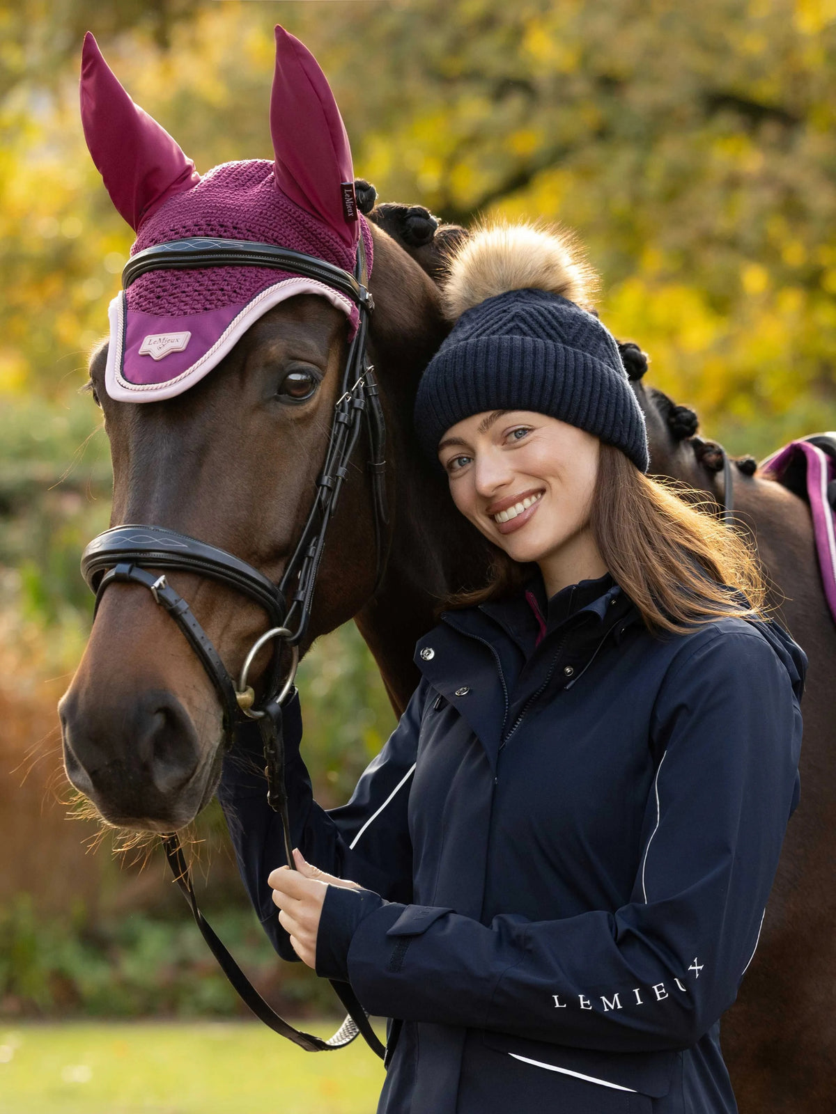 Rider wearing the LeMieux Clara Rib Beanie in Navy alongside a horse