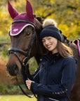 Rider wearing the LeMieux Clara Rib Beanie in Navy alongside a horse