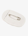 LeMieux silicone saddle pad number holder in white, back view showing the stainless steel safety pin