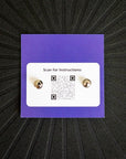 Pinsnickety Lightning Bolt horse show number pins from the back, showing locking clasps and QR code with instructions